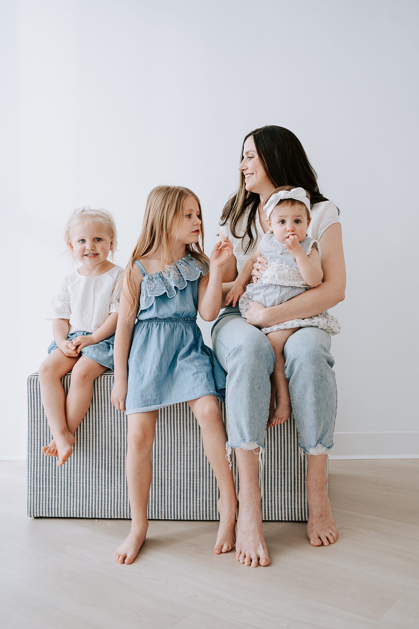 A mom holding her three daughters at a photography event for moms in roanoke texas.