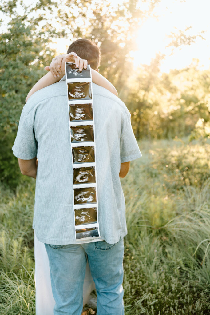 North Texas maternity photography session at Lake Grapevine with expecting parents announcing baby boy